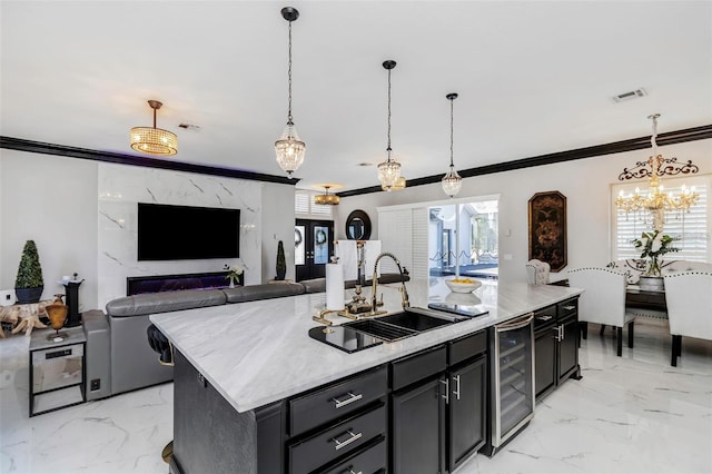 kitchen featuring marble finish floor, beverage cooler, visible vents, and a sink