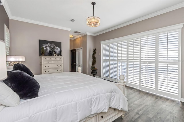 bedroom with visible vents, a closet, ornamental molding, and wood finished floors