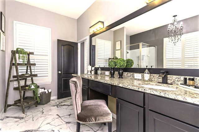 full bathroom with vanity, baseboards, marble finish floor, a stall shower, and an inviting chandelier