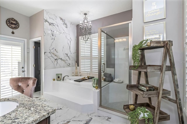 bathroom featuring a garden tub, marble finish floor, an inviting chandelier, vanity, and a shower stall