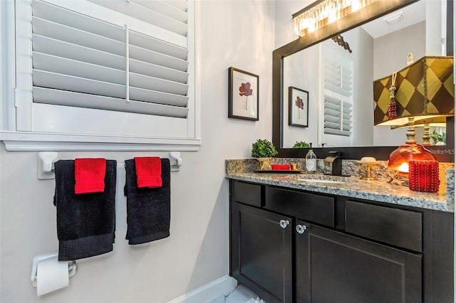 bathroom featuring baseboards and vanity