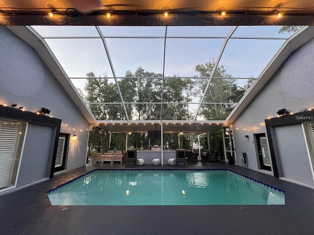 pool featuring a lanai, outdoor lounge area, and a patio