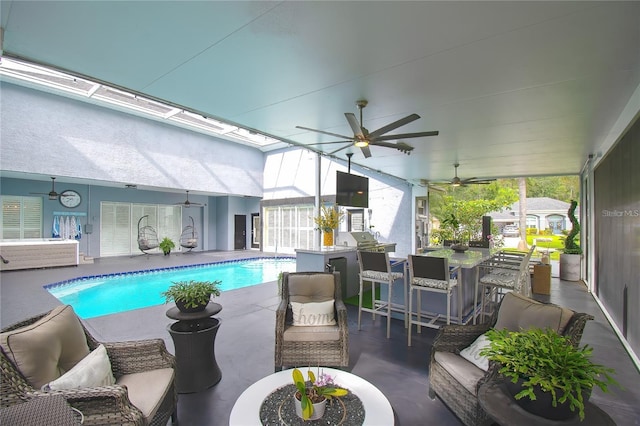 pool with a patio, outdoor dining area, and a ceiling fan