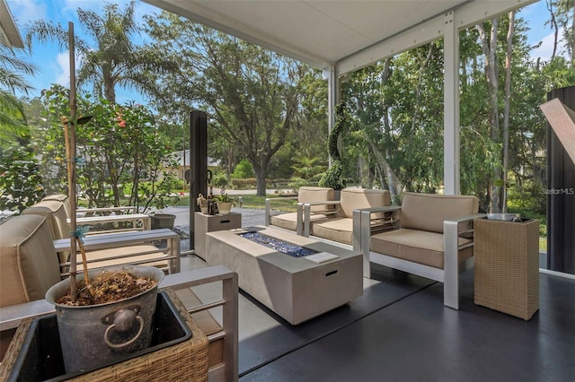 view of patio with an outdoor living space with a fire pit