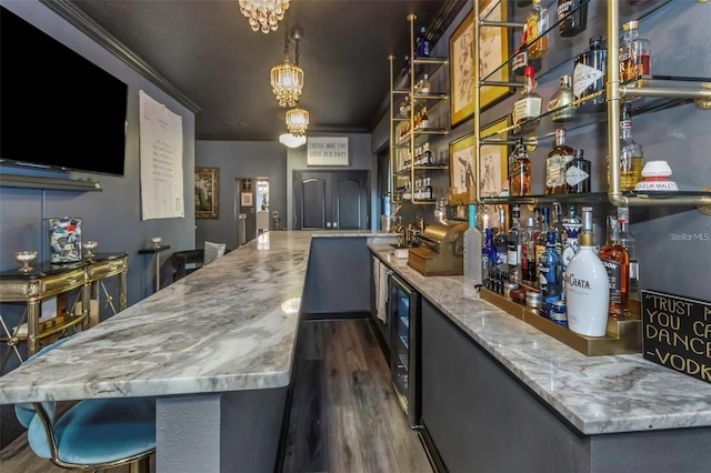 bar with beverage cooler, indoor wet bar, wood finished floors, and crown molding