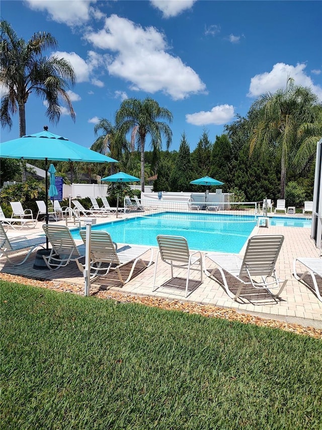 community pool featuring a patio area and fence