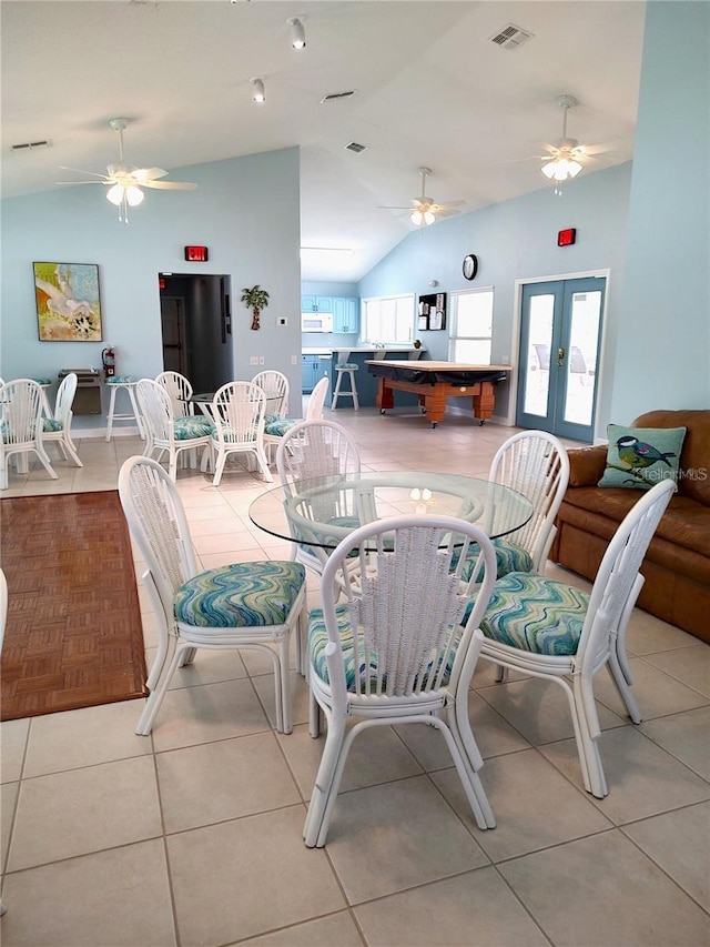 dining room featuring visible vents, a ceiling fan, lofted ceiling, tile patterned flooring, and french doors