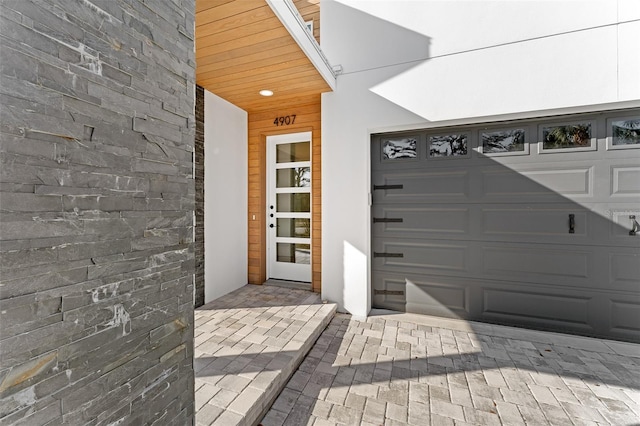 mudroom featuring brick floor and wood ceiling