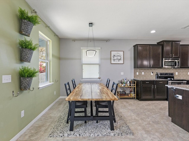 dining room with recessed lighting, light tile patterned flooring, and baseboards