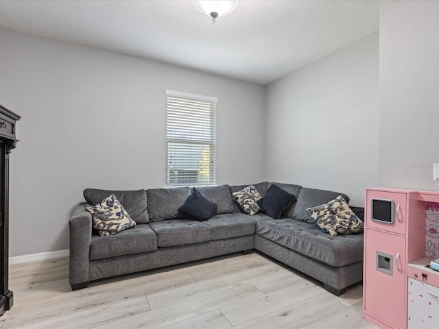 living area featuring light wood-type flooring and baseboards