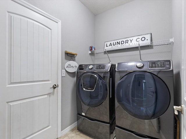 clothes washing area featuring baseboards, laundry area, tile patterned floors, and washer and dryer