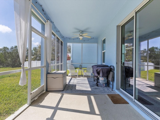 sunroom featuring ceiling fan