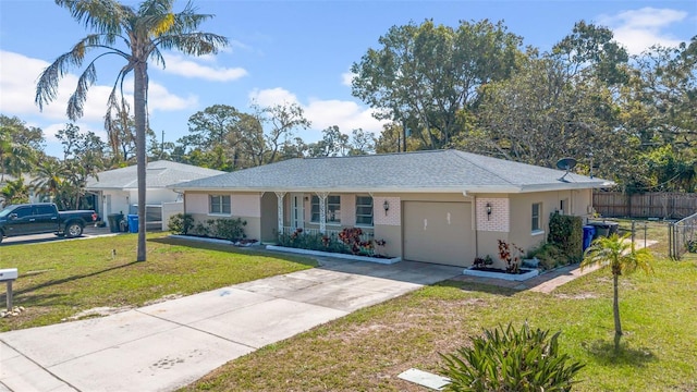 ranch-style house with a garage, brick siding, fence, concrete driveway, and a front yard