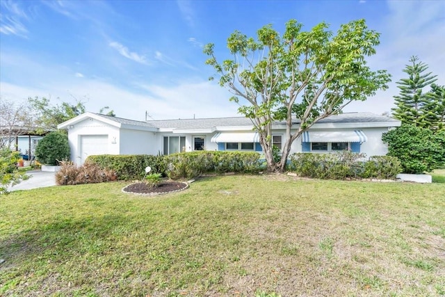 ranch-style house with an attached garage, stucco siding, driveway, and a front yard