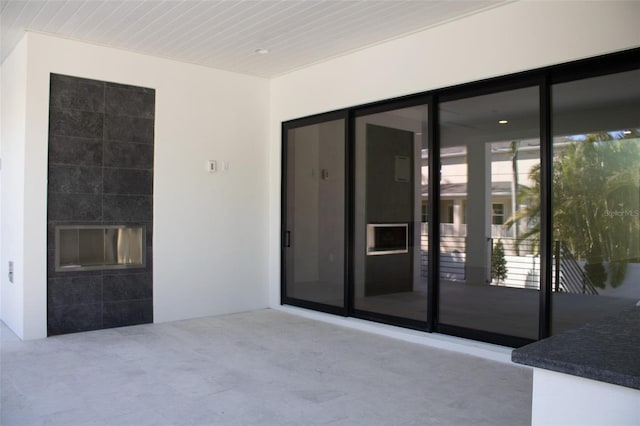 doorway to property with a patio and stucco siding