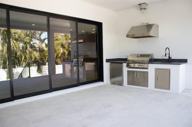 view of patio with a grill, a sink, and area for grilling