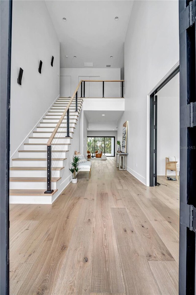 5017 W Dickens Ave, Tampa, FL 33629 - entrance foyer featuring a high ceiling, stairs, wood finished floors, and baseboards