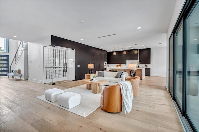 5017 W Dickens Ave, Tampa, FL 33629 - living area with light wood-style floors, stairs, baseboards, and recessed lighting