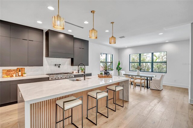 5017 W Dickens Ave, Tampa, FL 33629 - kitchen with modern cabinets, a sink, recessed lighting, light wood finished floors, and hanging light fixtures