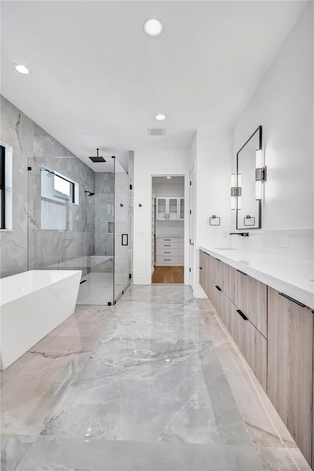 5017 W Dickens Ave, Tampa, FL 33629 - full bathroom featuring a marble finish shower, marble tiled floors, vanity, a freestanding tub, and a walk in closet