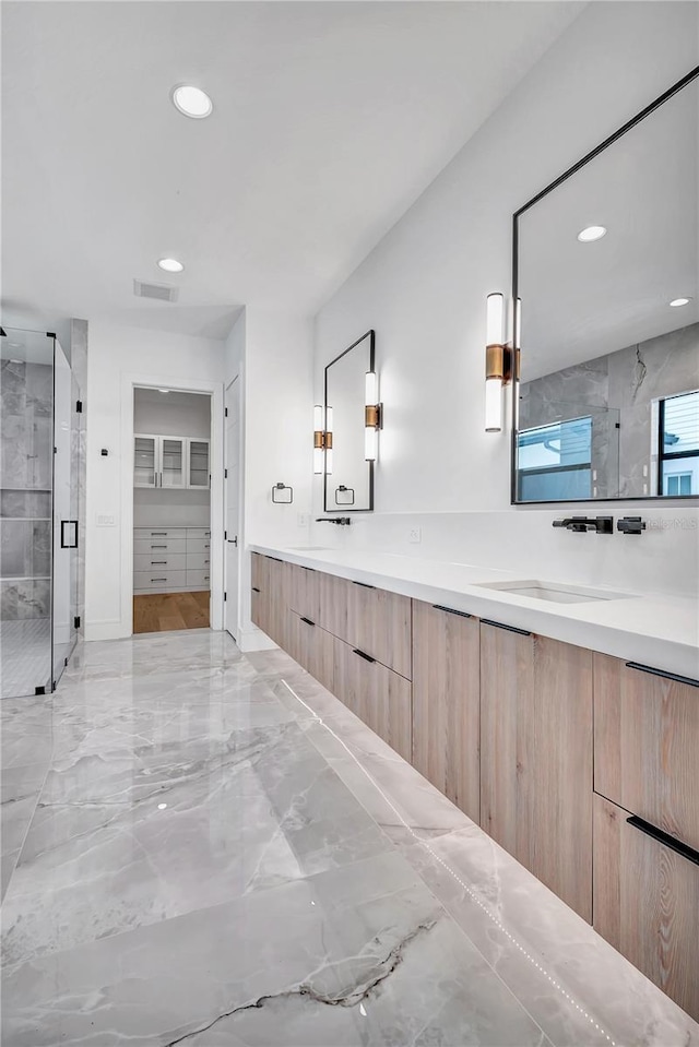 5017 W Dickens Ave, Tampa, FL 33629 - bathroom featuring marble tiled flooring, a shower stall, double vanity, recessed lighting, and a spacious closet