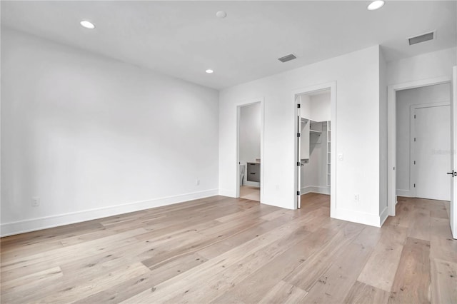 5017 W Dickens Ave, Tampa, FL 33629 - unfurnished bedroom with light wood finished floors, a spacious closet, baseboards, recessed lighting, and a closet