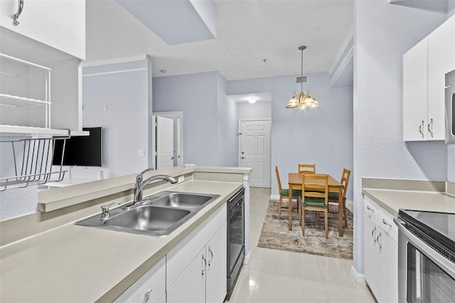 kitchen featuring a notable chandelier, white cabinetry, light countertops, and a sink