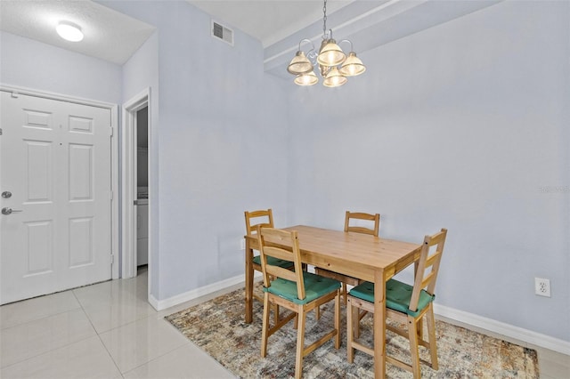 dining space with an inviting chandelier, visible vents, baseboards, and light tile patterned floors