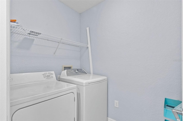 clothes washing area with laundry area and washing machine and clothes dryer