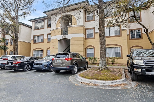 view of building exterior featuring uncovered parking