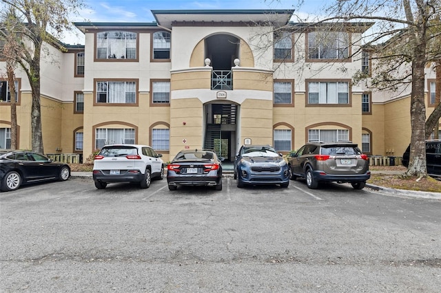 view of building exterior with uncovered parking