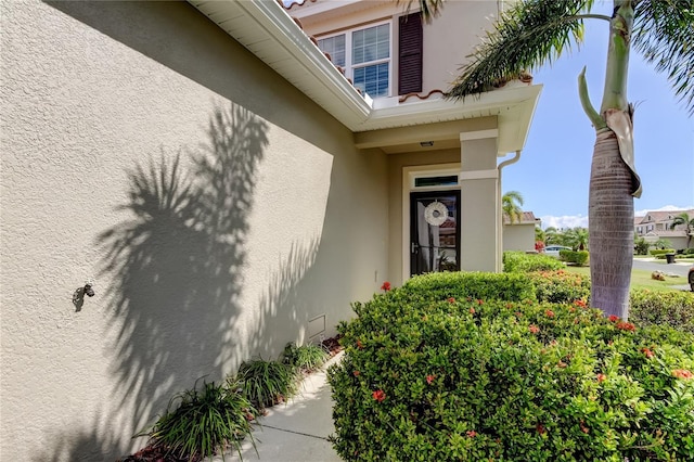 property entrance with stucco siding