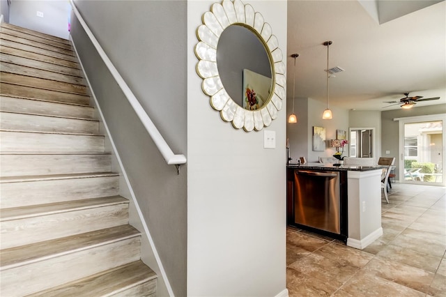 stairs featuring visible vents and a ceiling fan