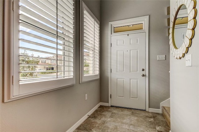 doorway featuring baseboards