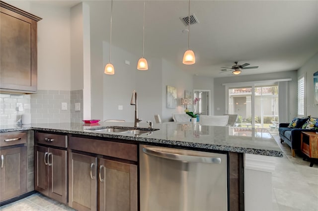 kitchen featuring dishwasher, dark stone counters, a sink, and visible vents