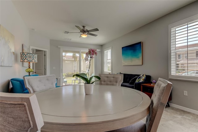 dining space featuring visible vents, a ceiling fan, and baseboards