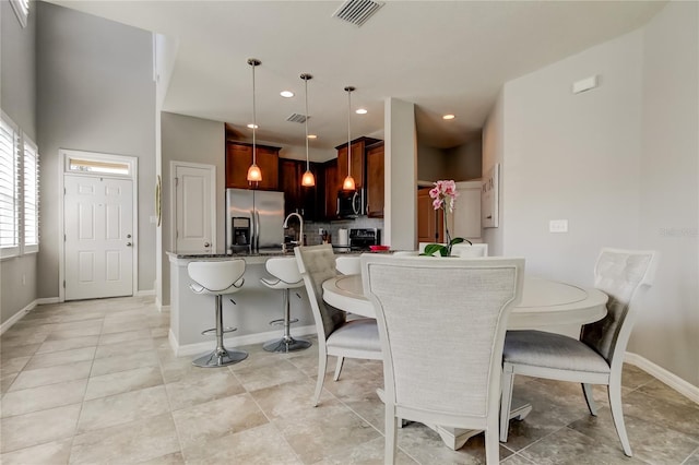 dining room featuring light tile patterned floors, baseboards, visible vents, and recessed lighting