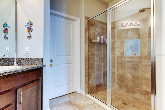 bathroom with a shower stall and vanity