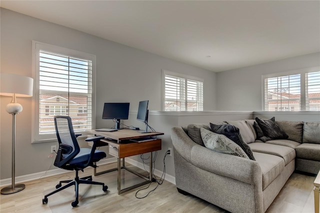 home office with light wood-style floors and baseboards