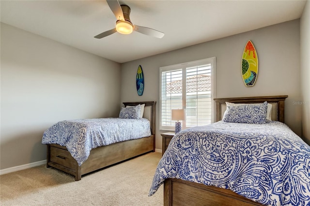 carpeted bedroom with baseboards and a ceiling fan