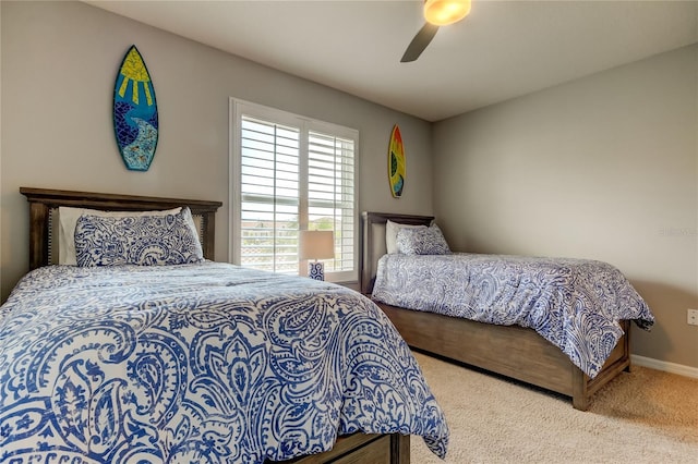 carpeted bedroom featuring ceiling fan and baseboards