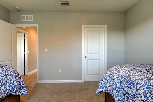 bedroom featuring carpet flooring, visible vents, and baseboards