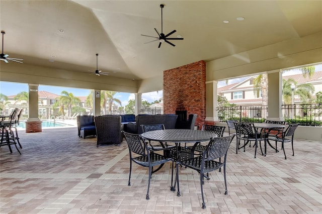 view of patio / terrace featuring outdoor dining space, fence, a ceiling fan, and a fenced in pool