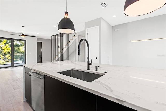 kitchen with pendant lighting, recessed lighting, visible vents, light wood-style flooring, and a sink