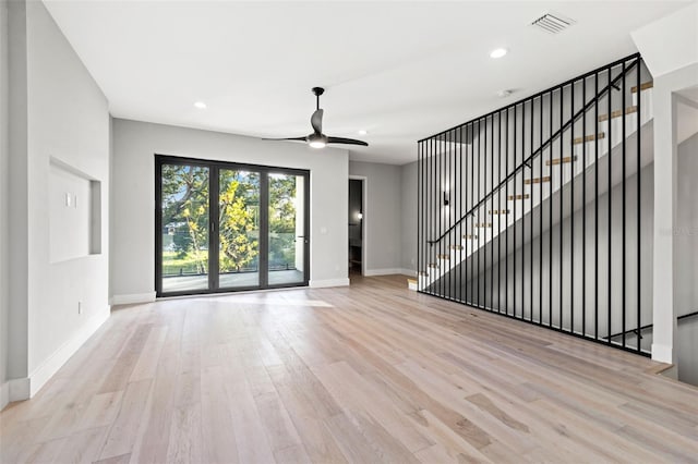 unfurnished living room with ceiling fan, recessed lighting, wood finished floors, visible vents, and baseboards