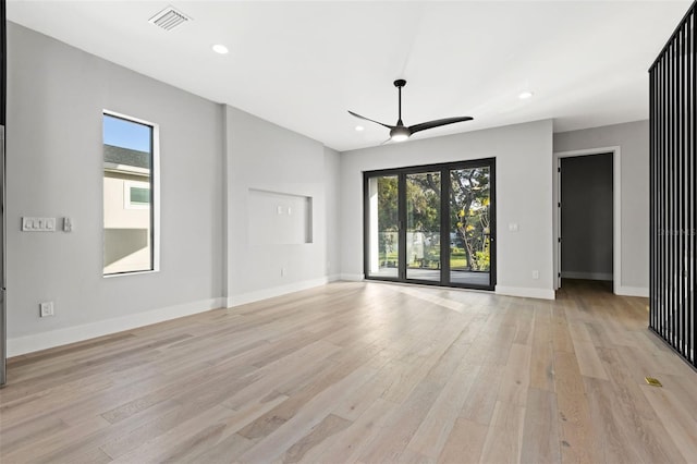 unfurnished living room featuring light wood-style floors, recessed lighting, visible vents, and plenty of natural light