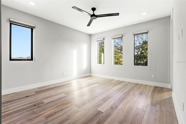 spare room featuring recessed lighting, baseboards, ceiling fan, and light wood finished floors