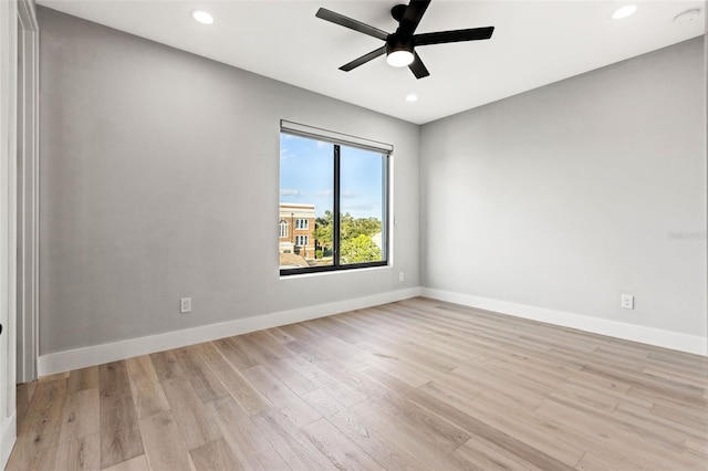 spare room featuring light wood-style flooring, baseboards, a ceiling fan, and recessed lighting