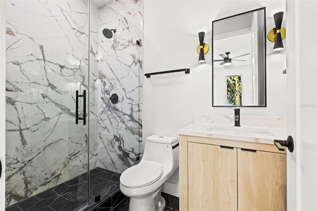 bathroom with toilet, a marble finish shower, and vanity