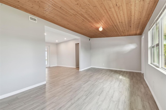 unfurnished room featuring wooden ceiling, visible vents, baseboards, and light wood finished floors